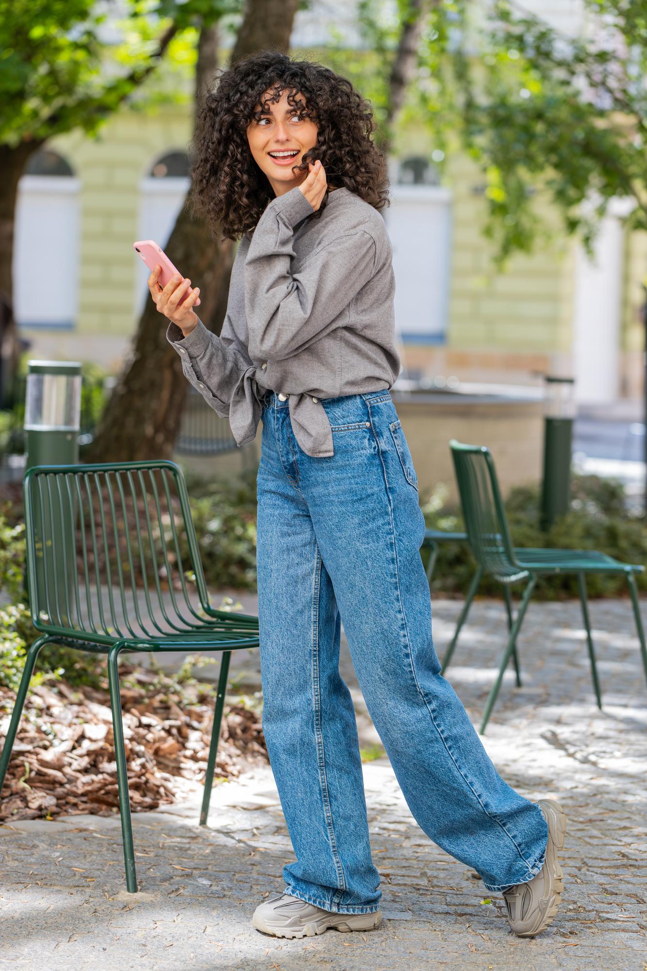 person wearing fitted indigo jeans casual styling