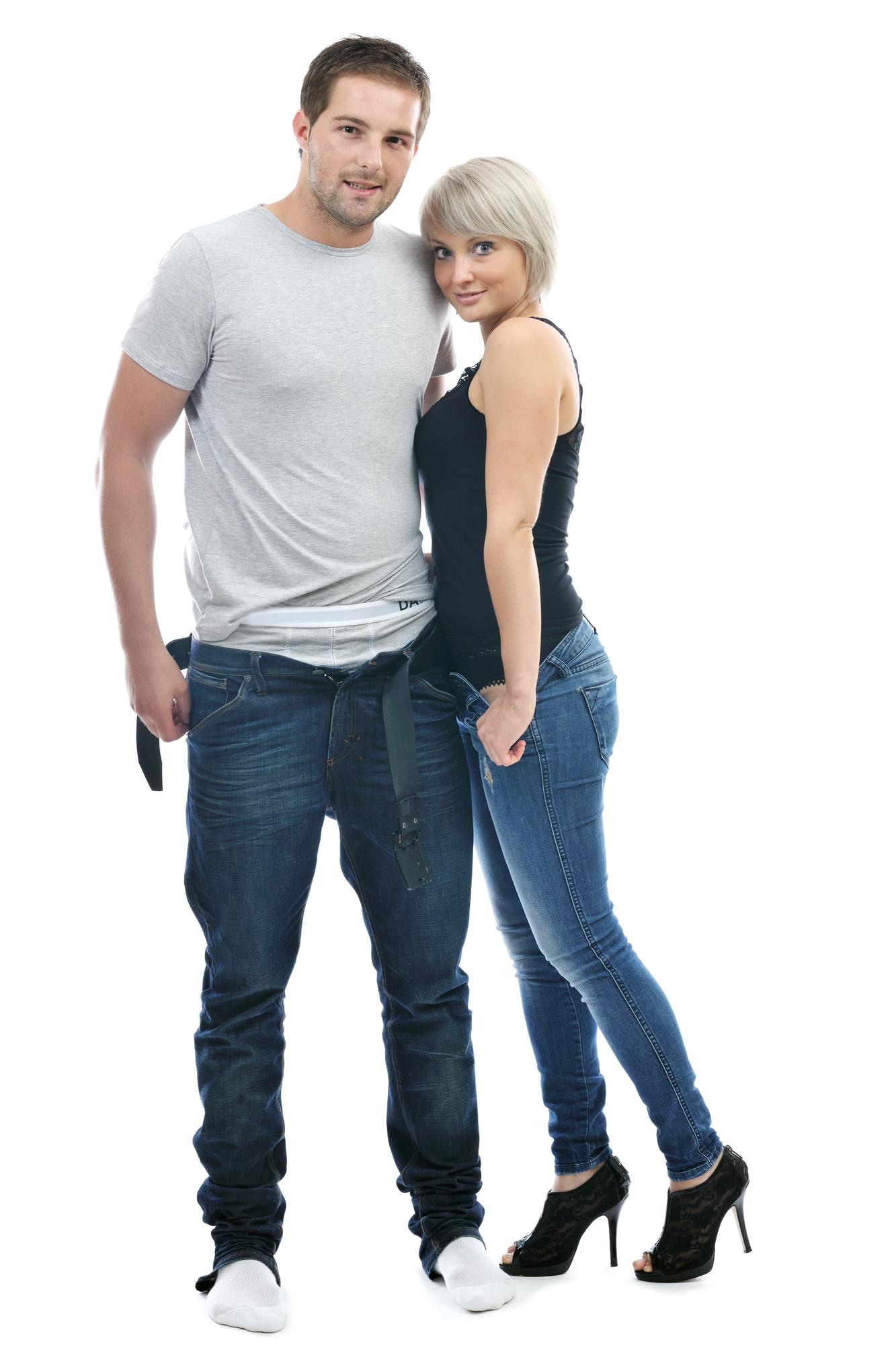 tailor measuring customer waist for custom jeans fitting